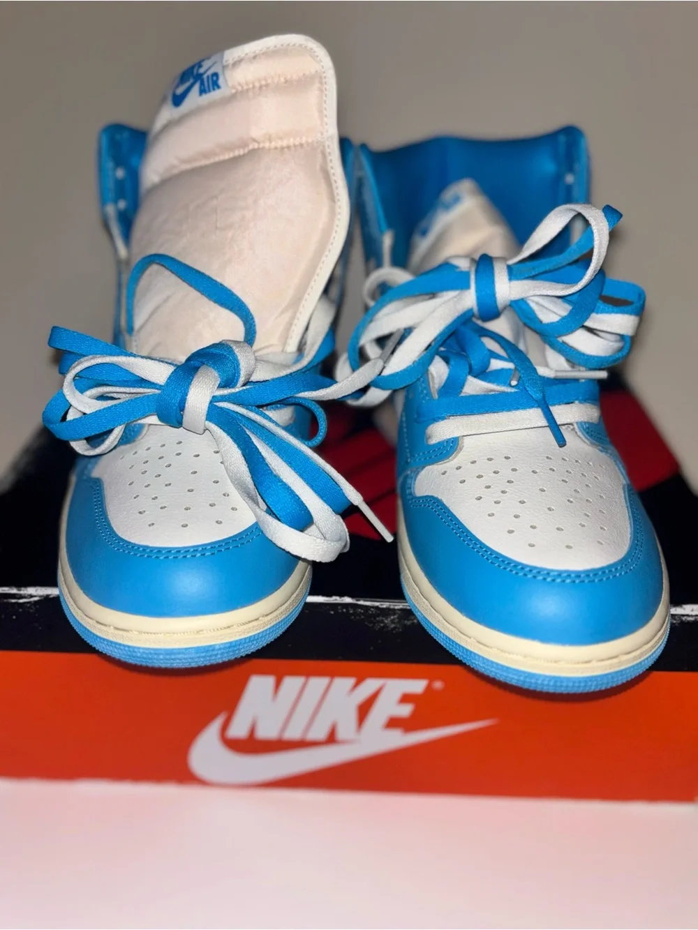 Jordan Air Jordan 1 Mid White and Blue Sneakers